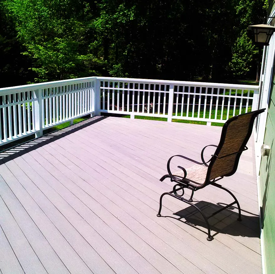Freshly stained deck with painted white railings