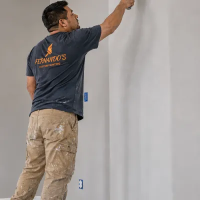 Fernando, owner and lead painter, rolling a wall