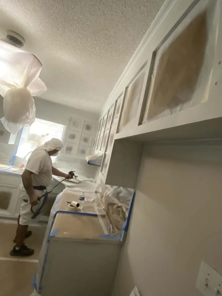 Fernando's painter spraying kitchen cabinets